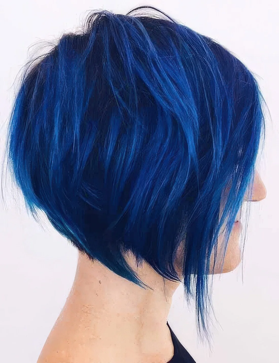 Extremely bold blue angled chopped bob with a lot of volume and textured hair.