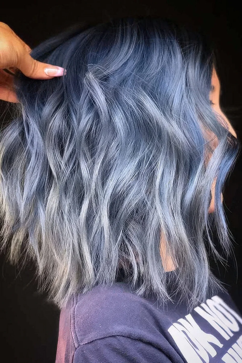 Photo showing ocean blue wavy long bob, with the hairstyle clearly visible.