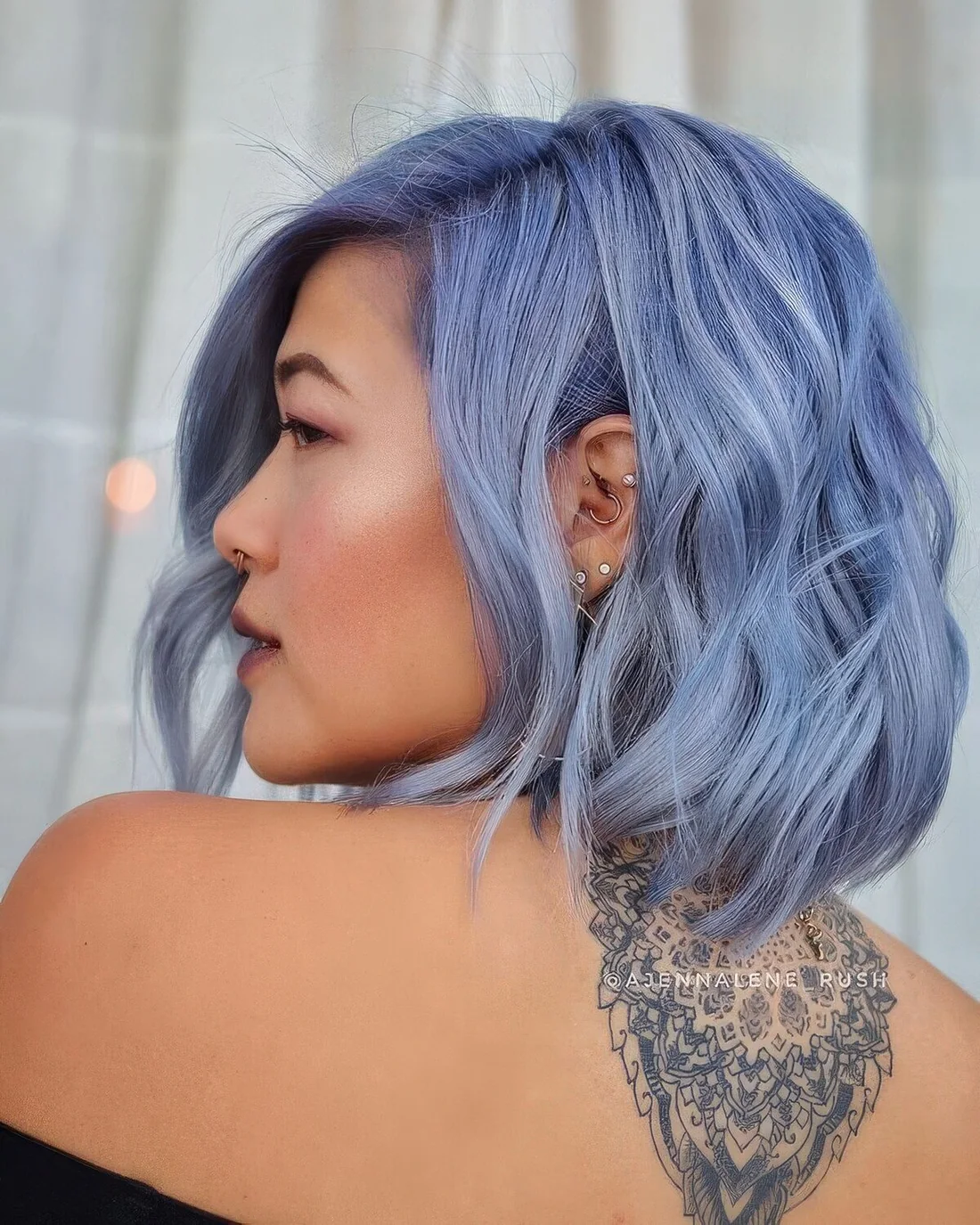 Ocean blue wavy hair with side part.