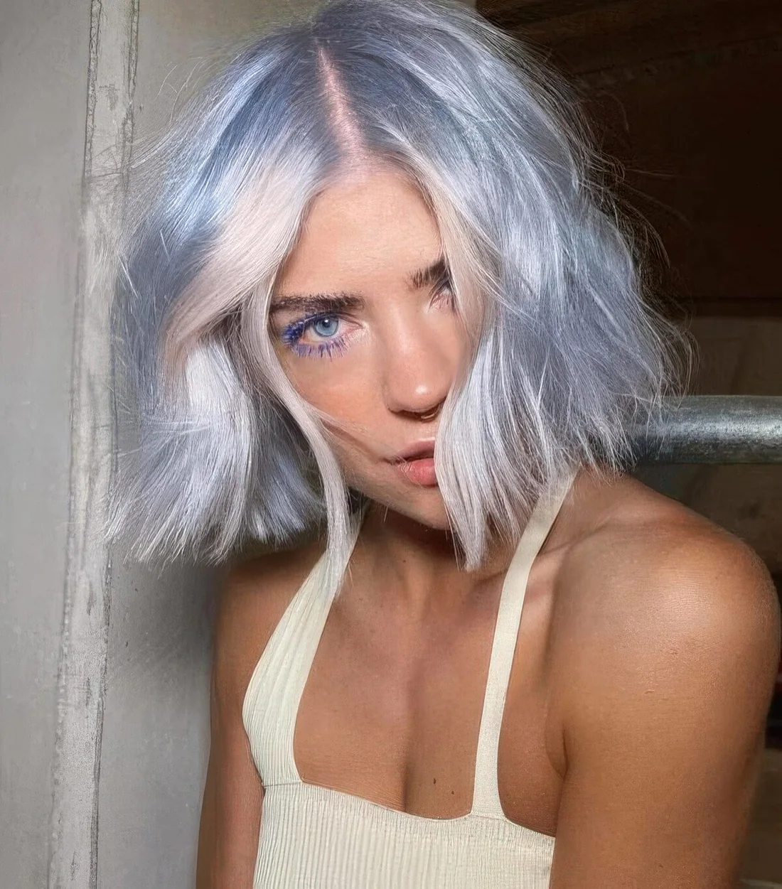 Short and wavy pastel blue hair with blush touches and texture.