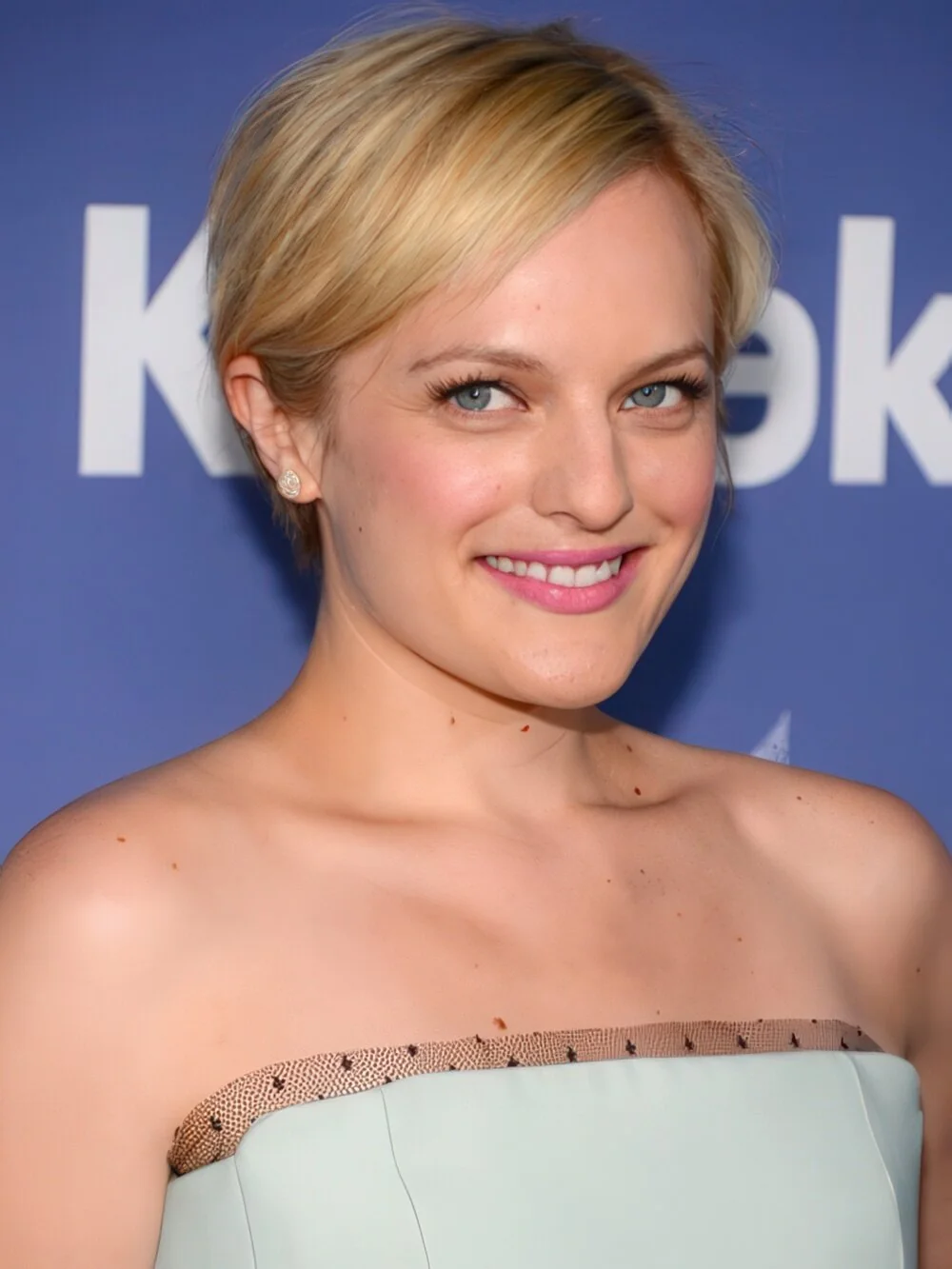 Sleek blonde pixie with side-swept bangs.