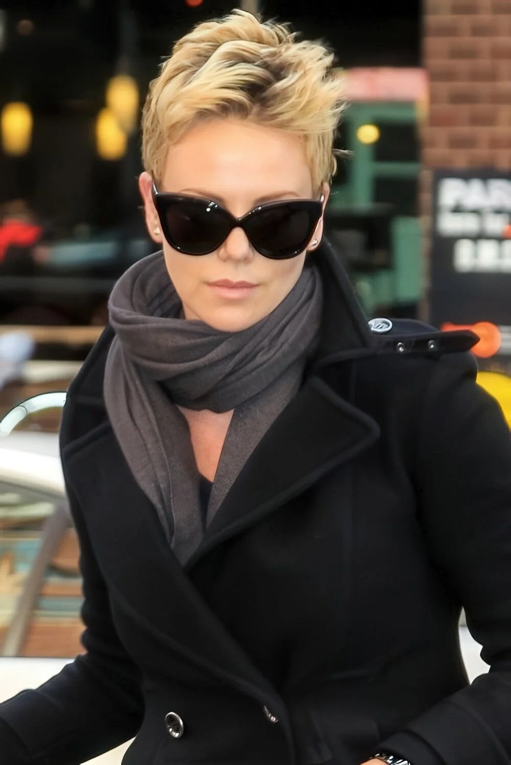 Textured blonde pixie swept up from the face.