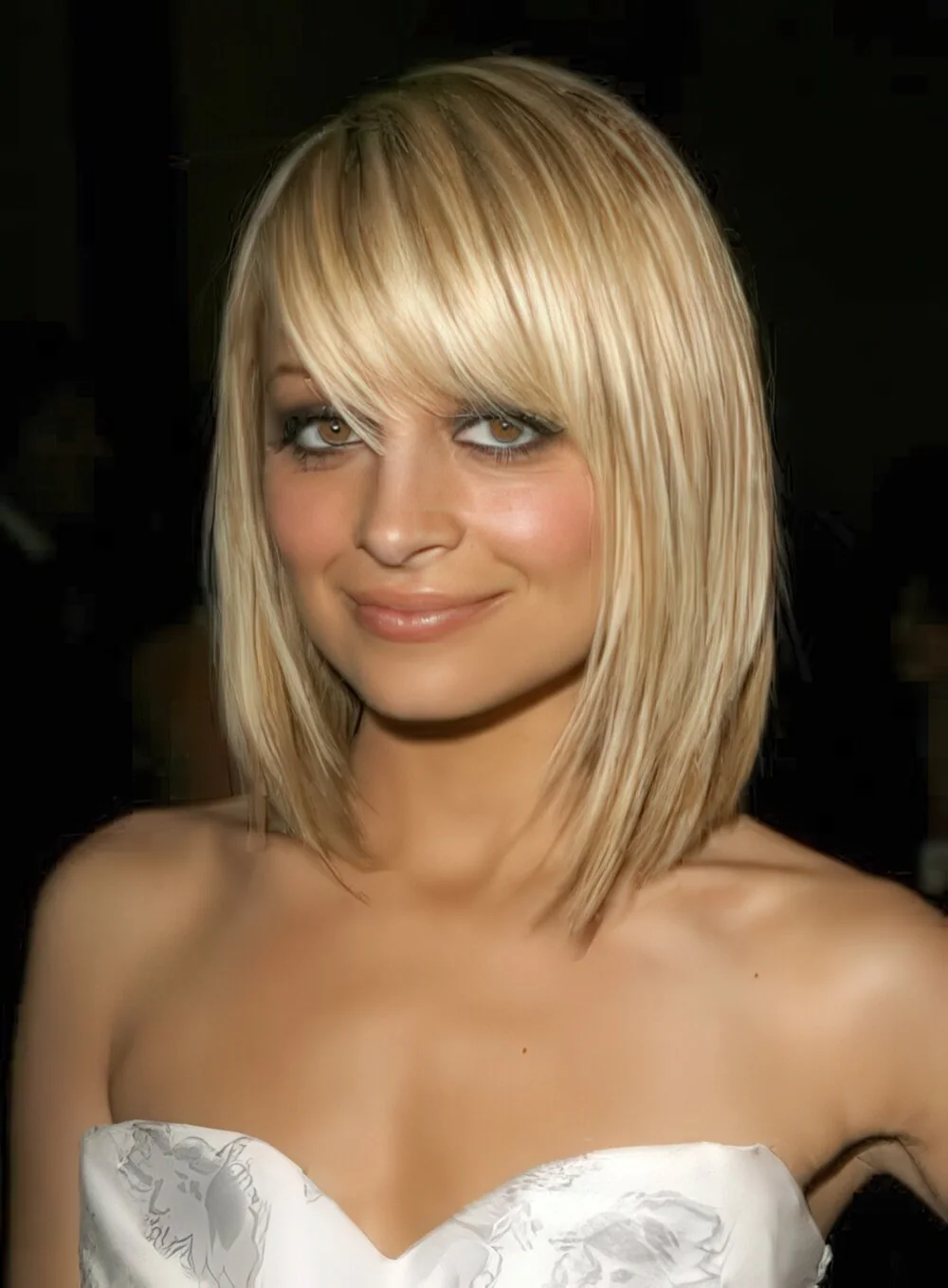 Blonde shoulder-length layers with full fringe.