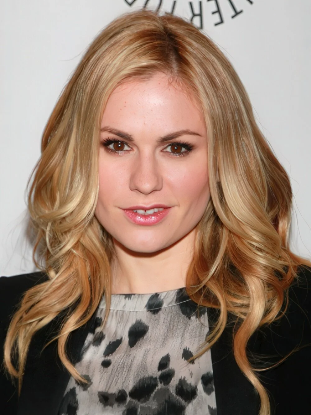 Long blonde layers with loose curls.
