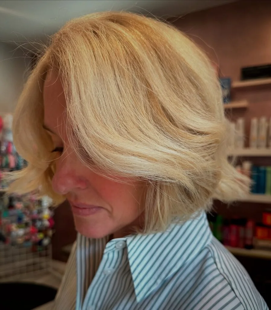 Side-swept blonde bob with airy face-framing.