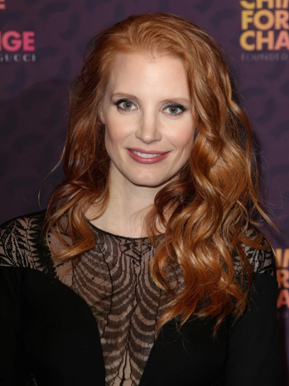 Long copper curls with a side part.