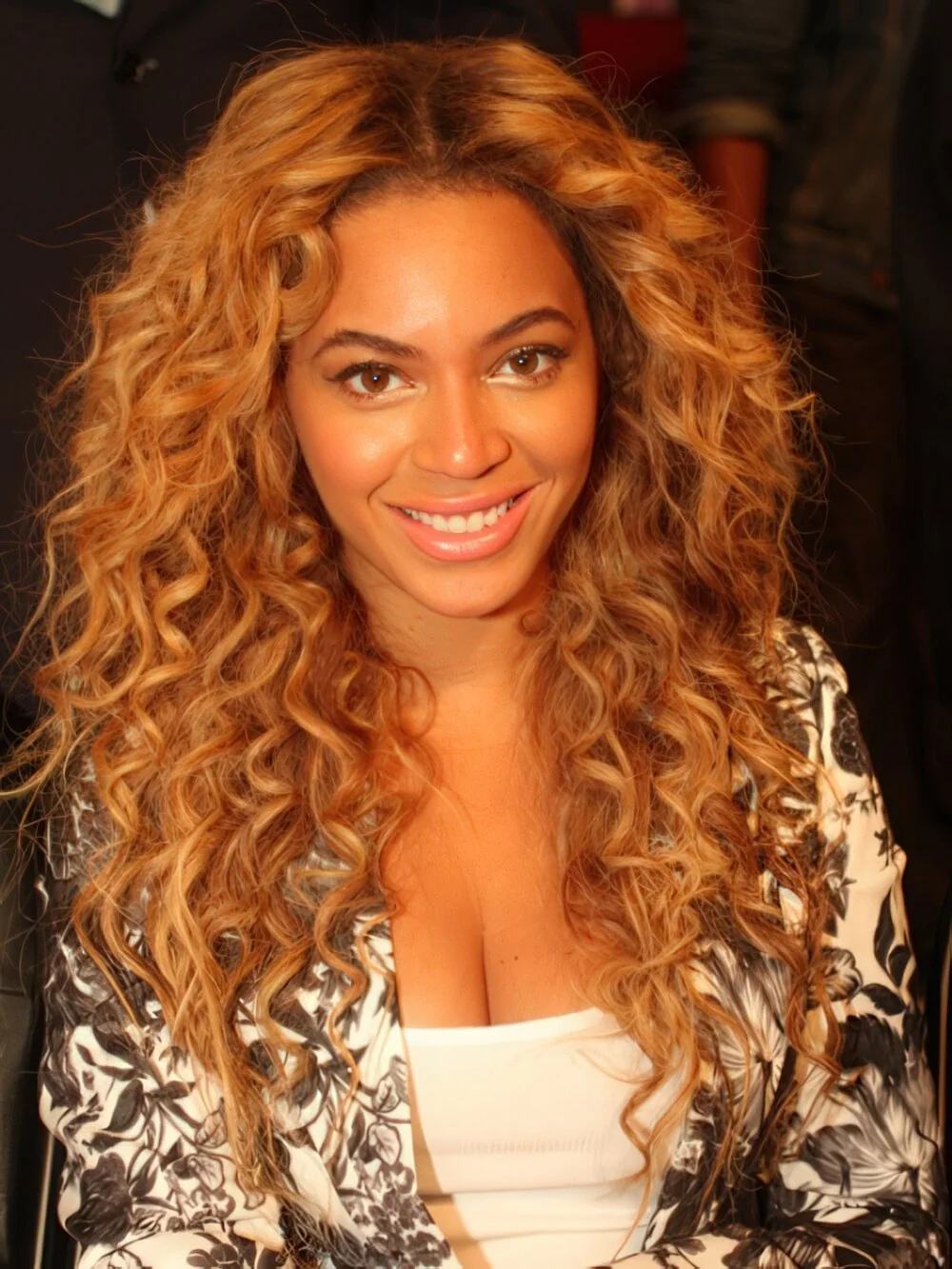 Long honey-blonde curls with a center part.