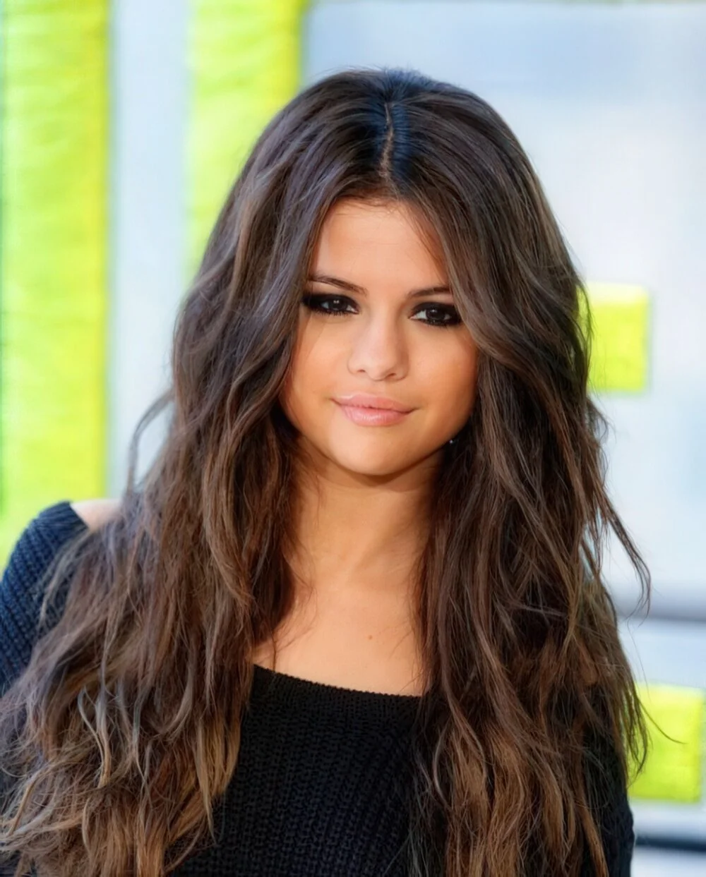 Long brunette waves with a center part.