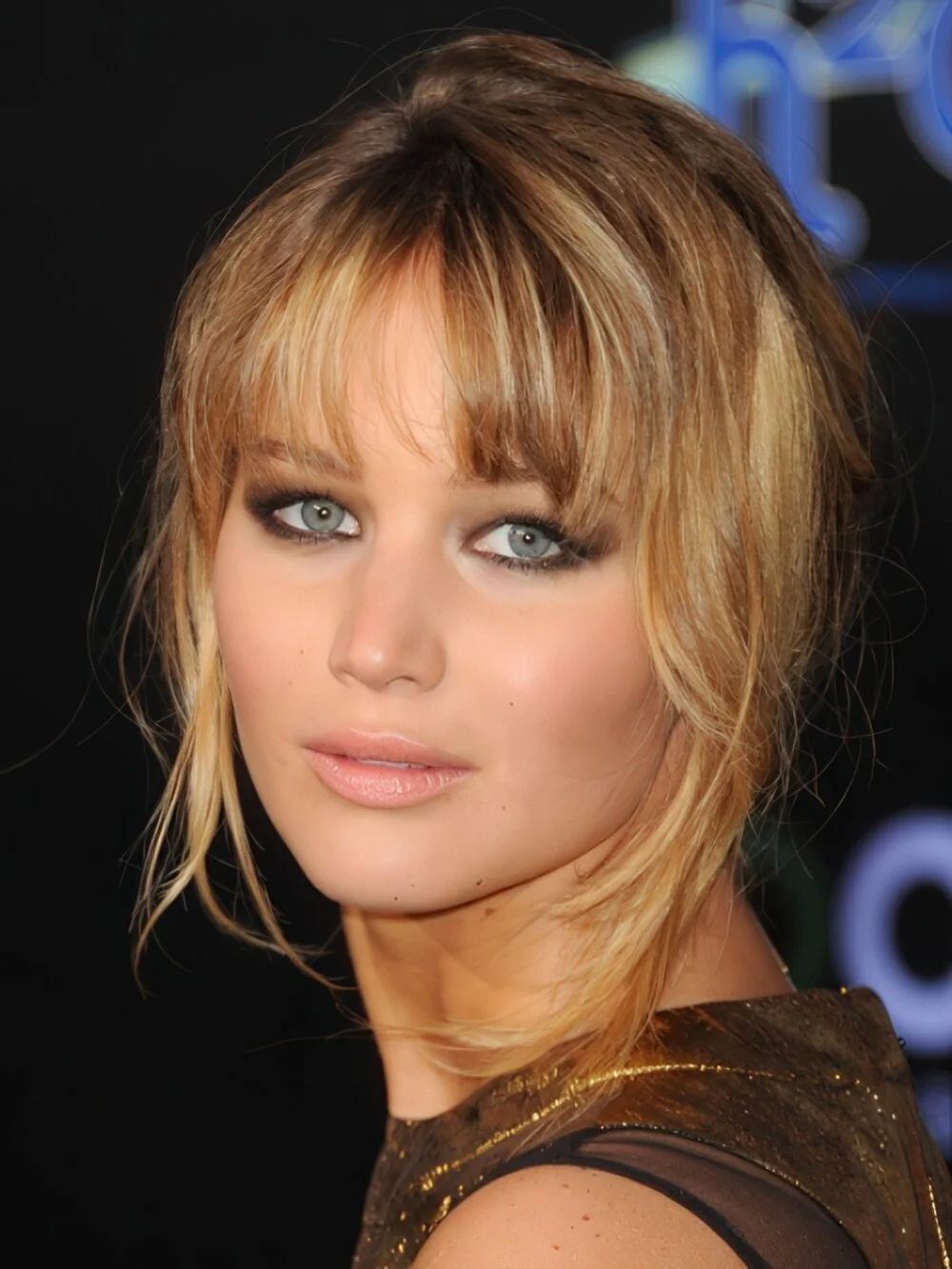 Long blonde layers with full bangs.