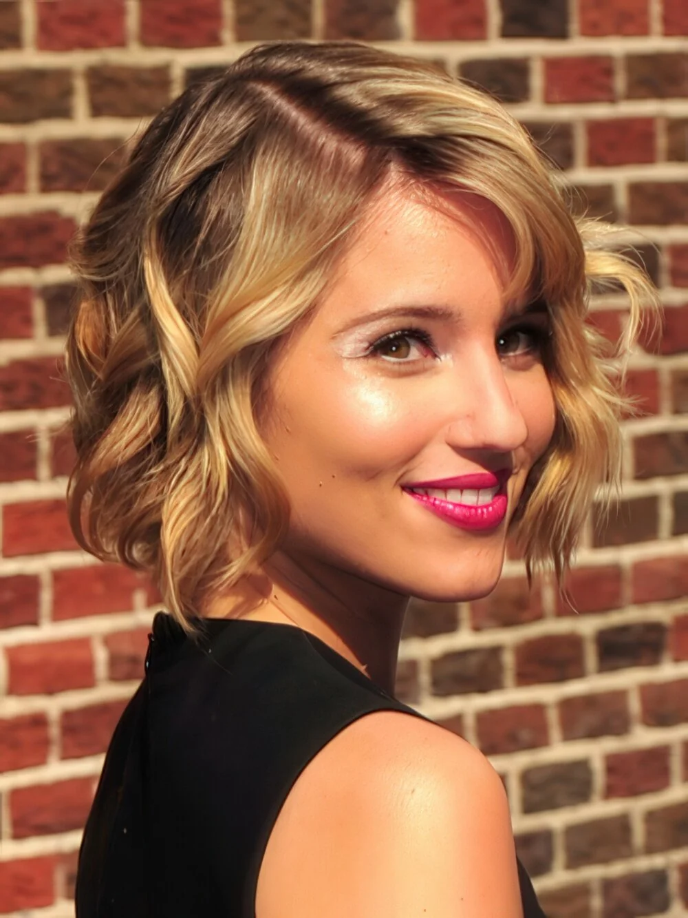 Short blonde curled bob with a side part.