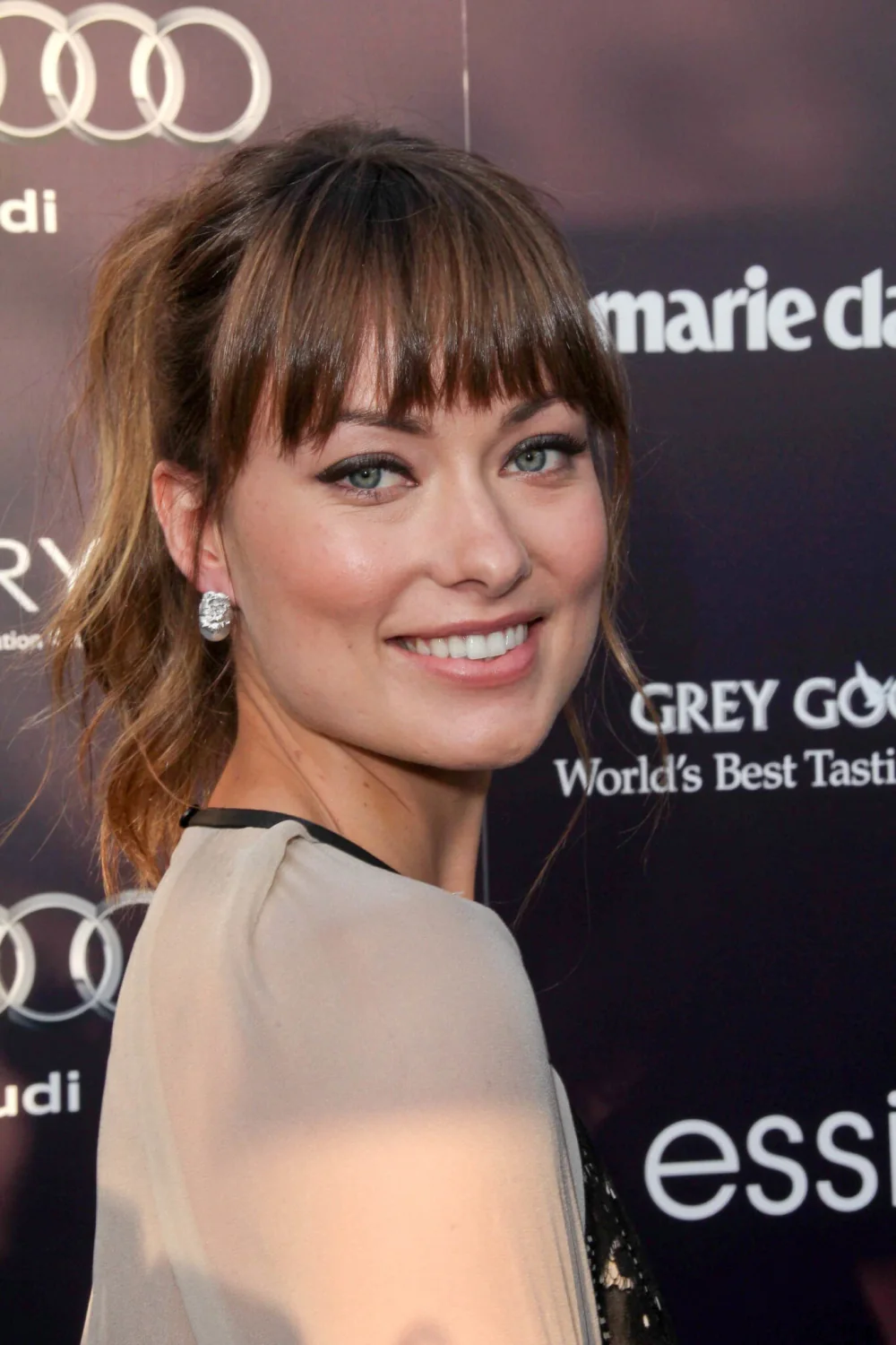High ponytail with a straight brow-length fringe.