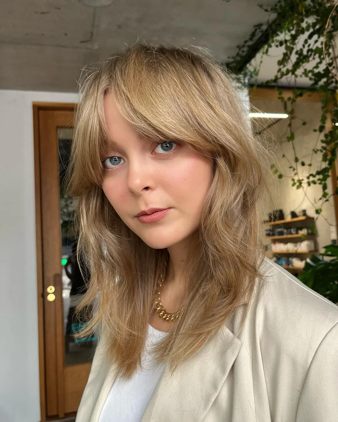 Long blonde layers with side-swept face-framing.