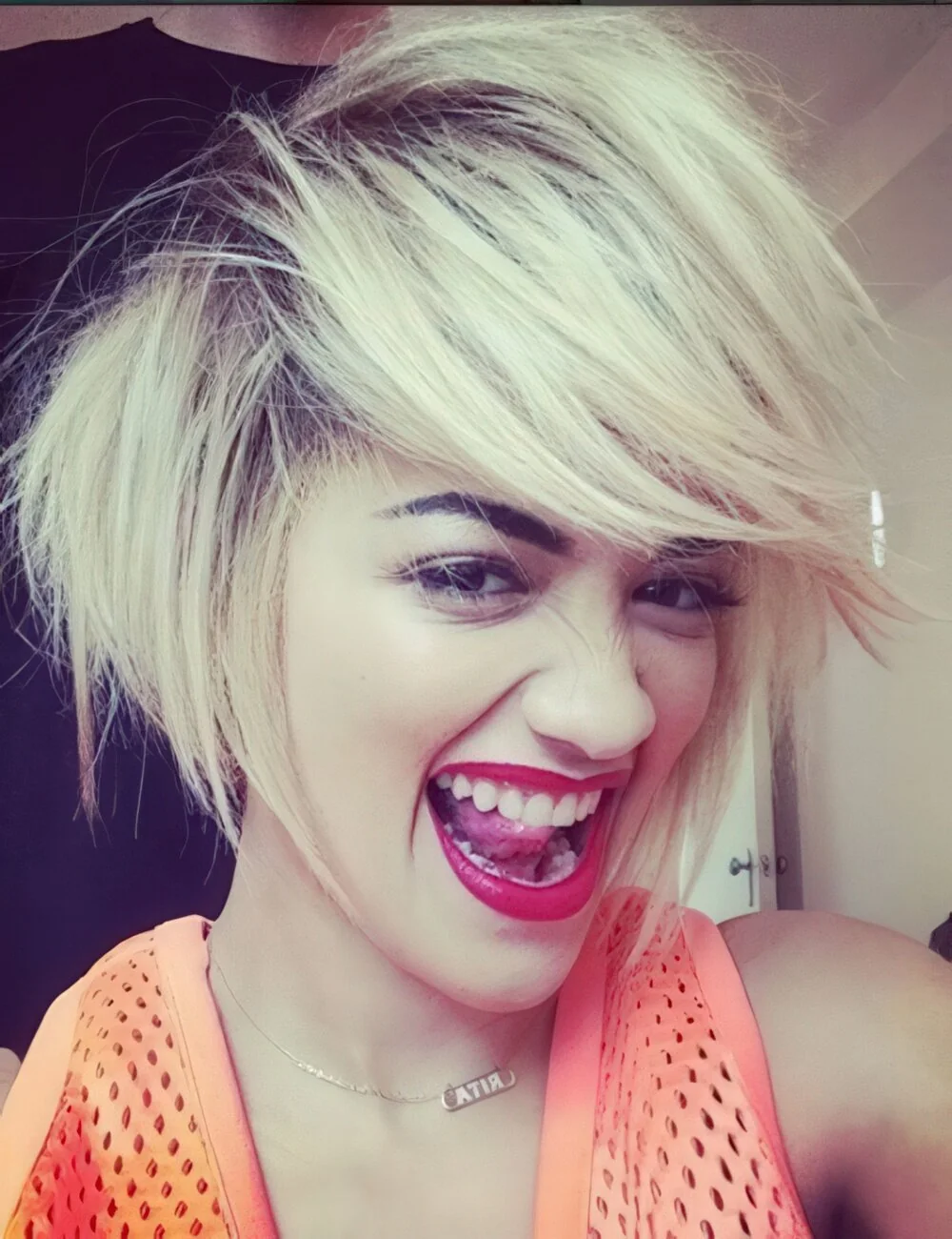 Tousled platinum pixie with side-swept bangs.