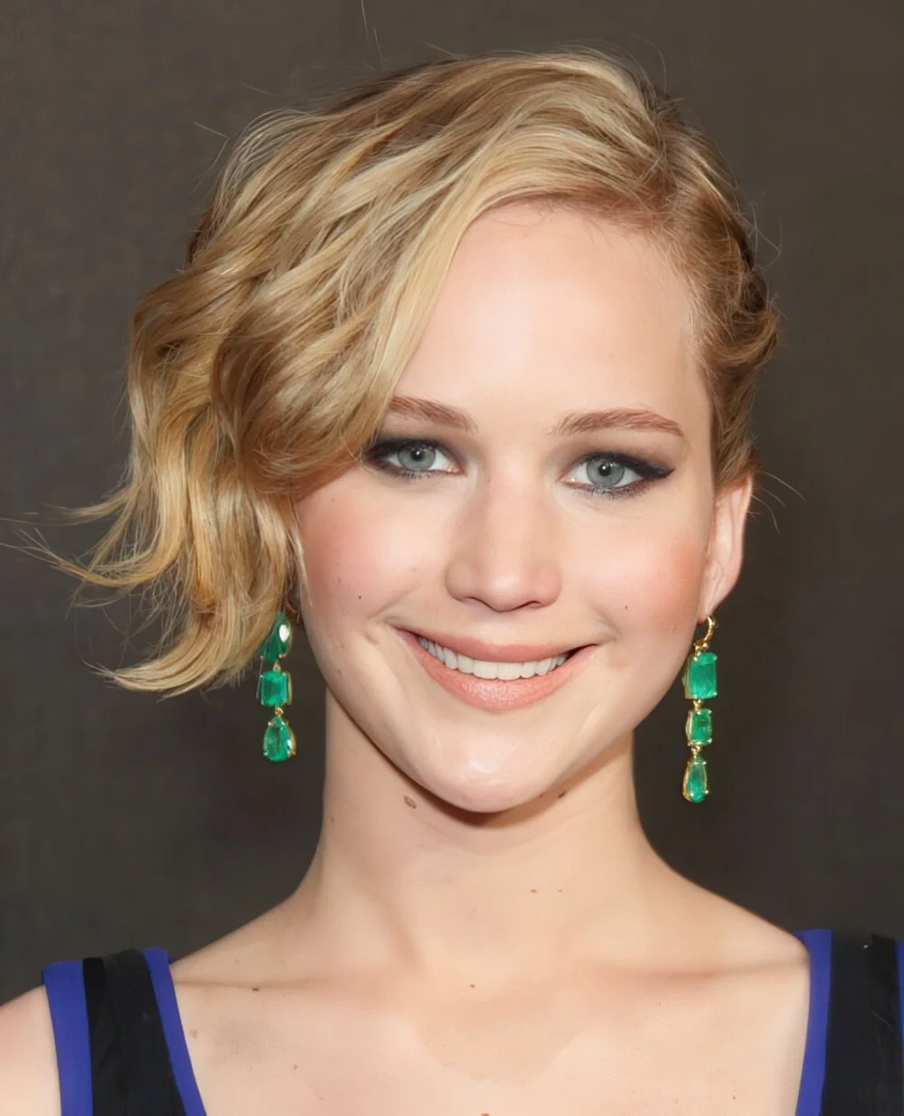 Short blonde wavy bob with a side part.