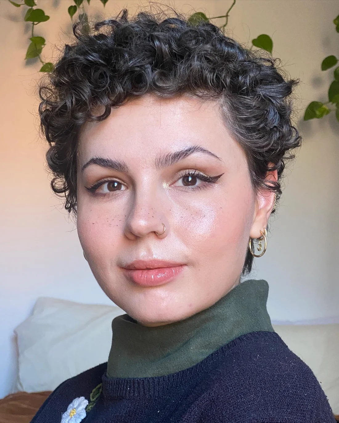 Photo showing defined Curly Pixie Cut, with the hairstyle clearly visible.