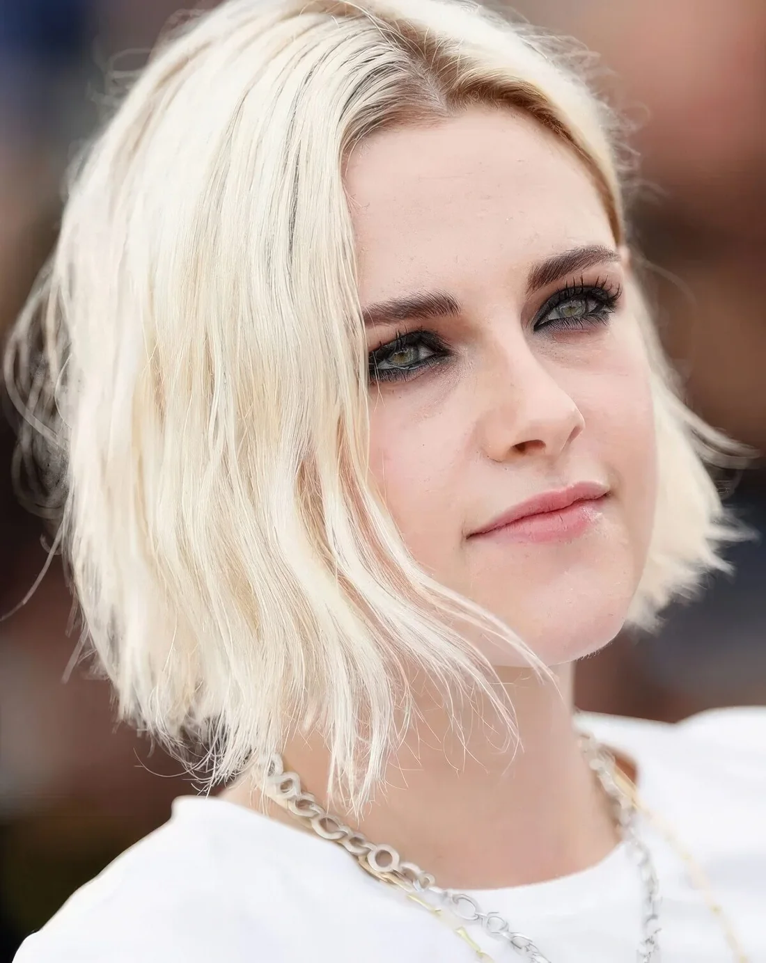 Photo showing bleached and loosely styled bob, with the hairstyle clearly visible.