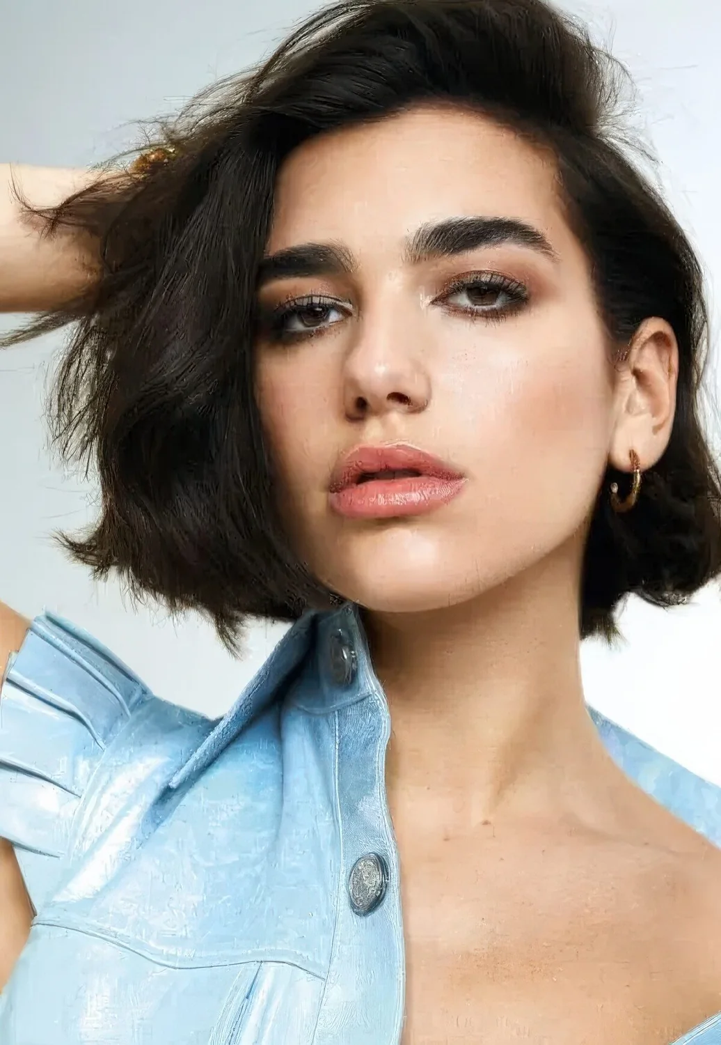 If you want volume like Dua Lipa, instead of creating a neat parting, run your fingers through your hair and flip it, then let it fall where it wants.