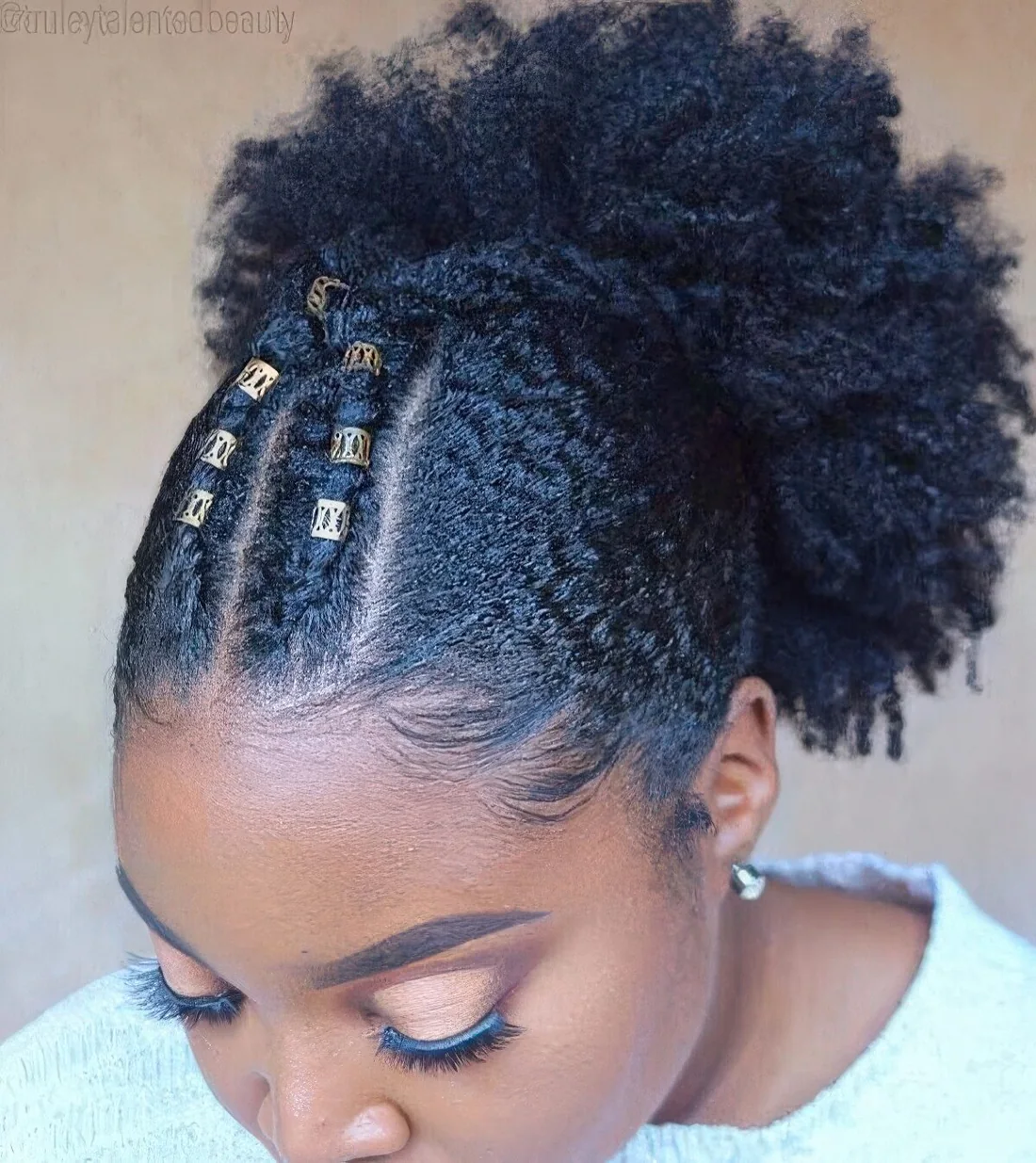 Crossover braid design at the front and a high puff at the back for a quick and natural hairstyle.