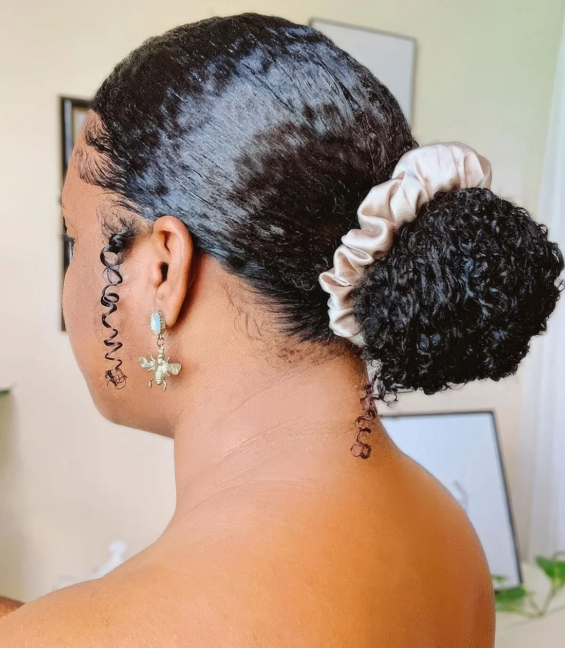Photo showing low curly bun, with the hairstyle clearly visible.