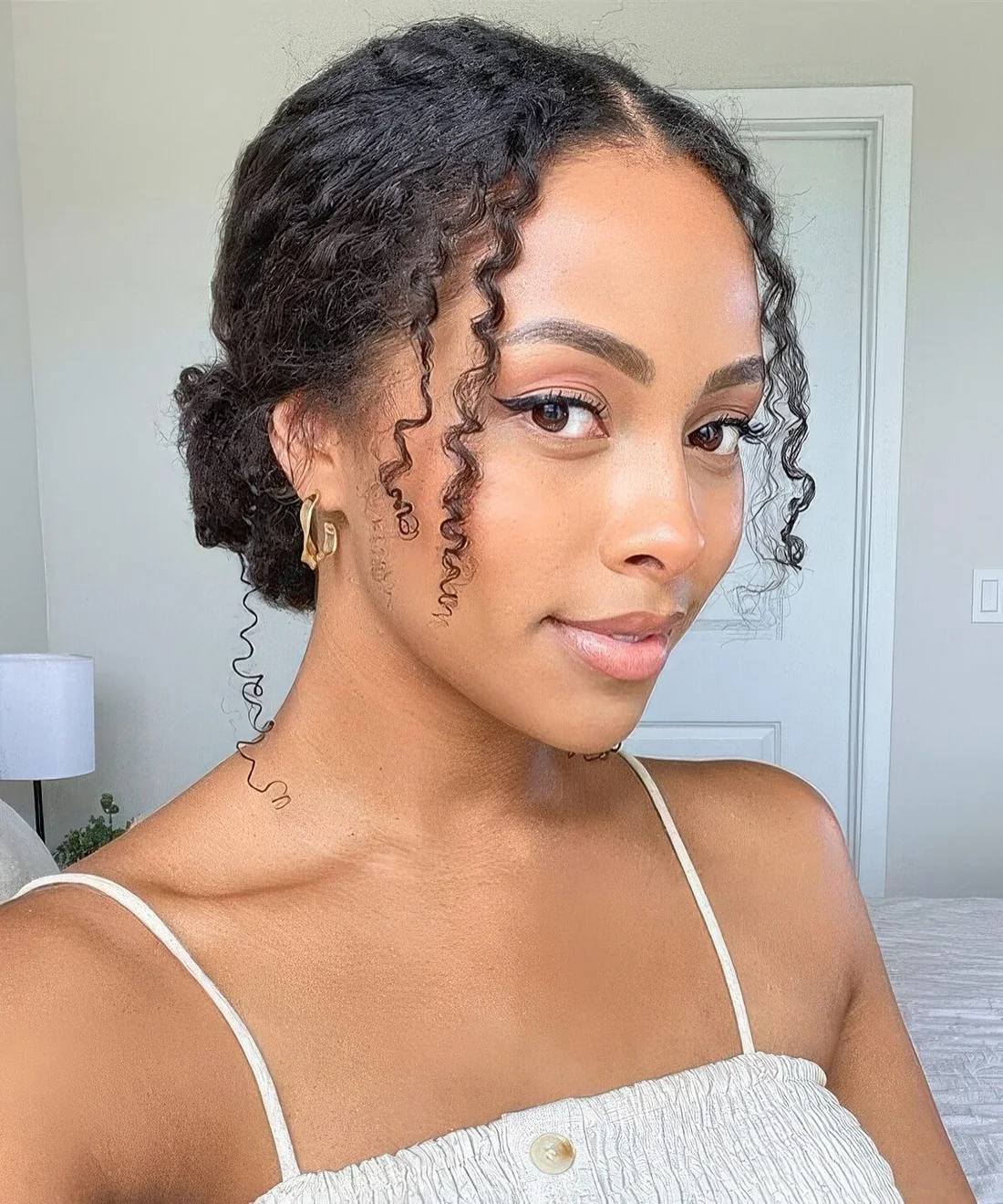 Classic low bun paired with losee curls.