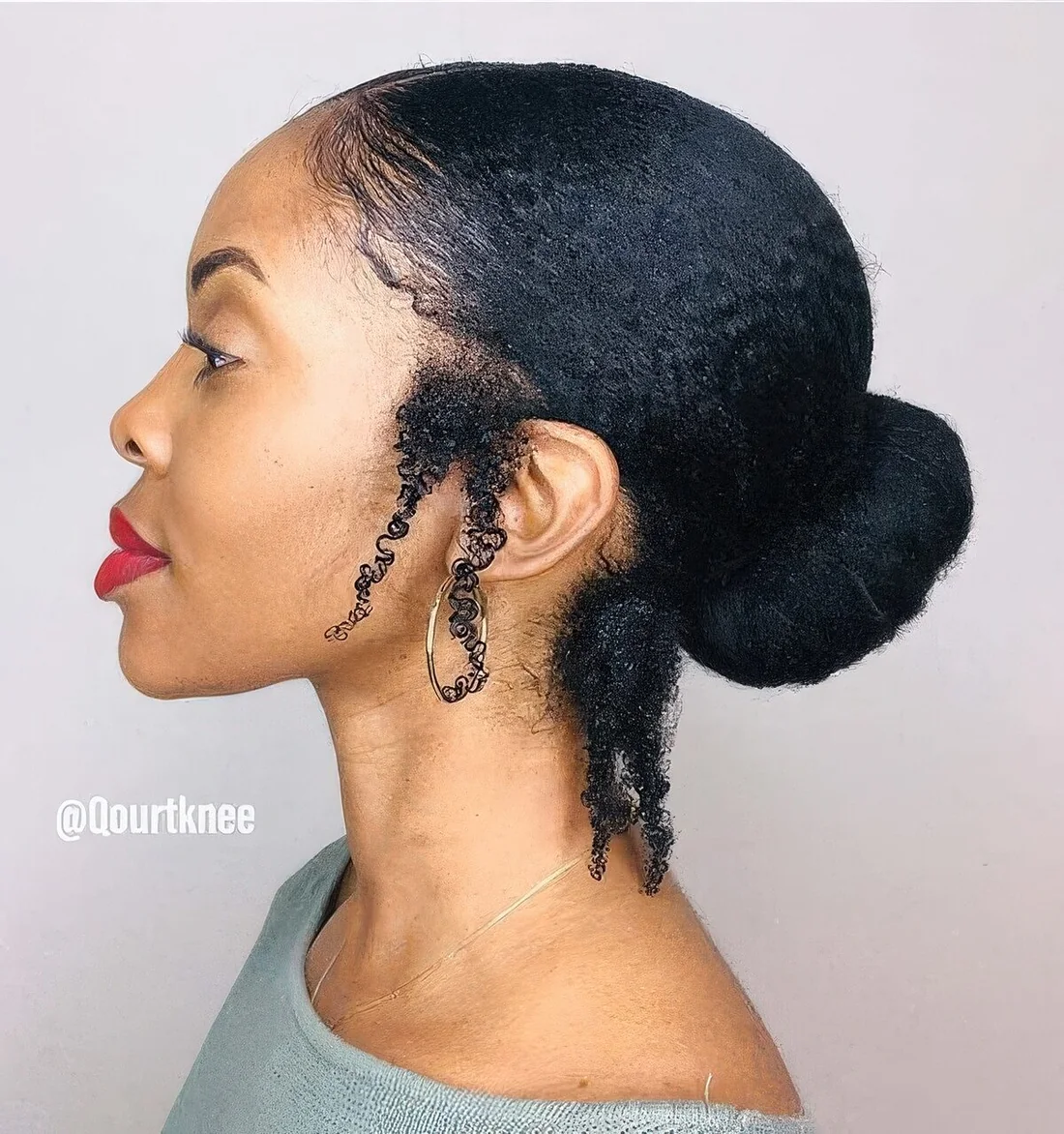 Low bun with some loose curls at the sides and back.