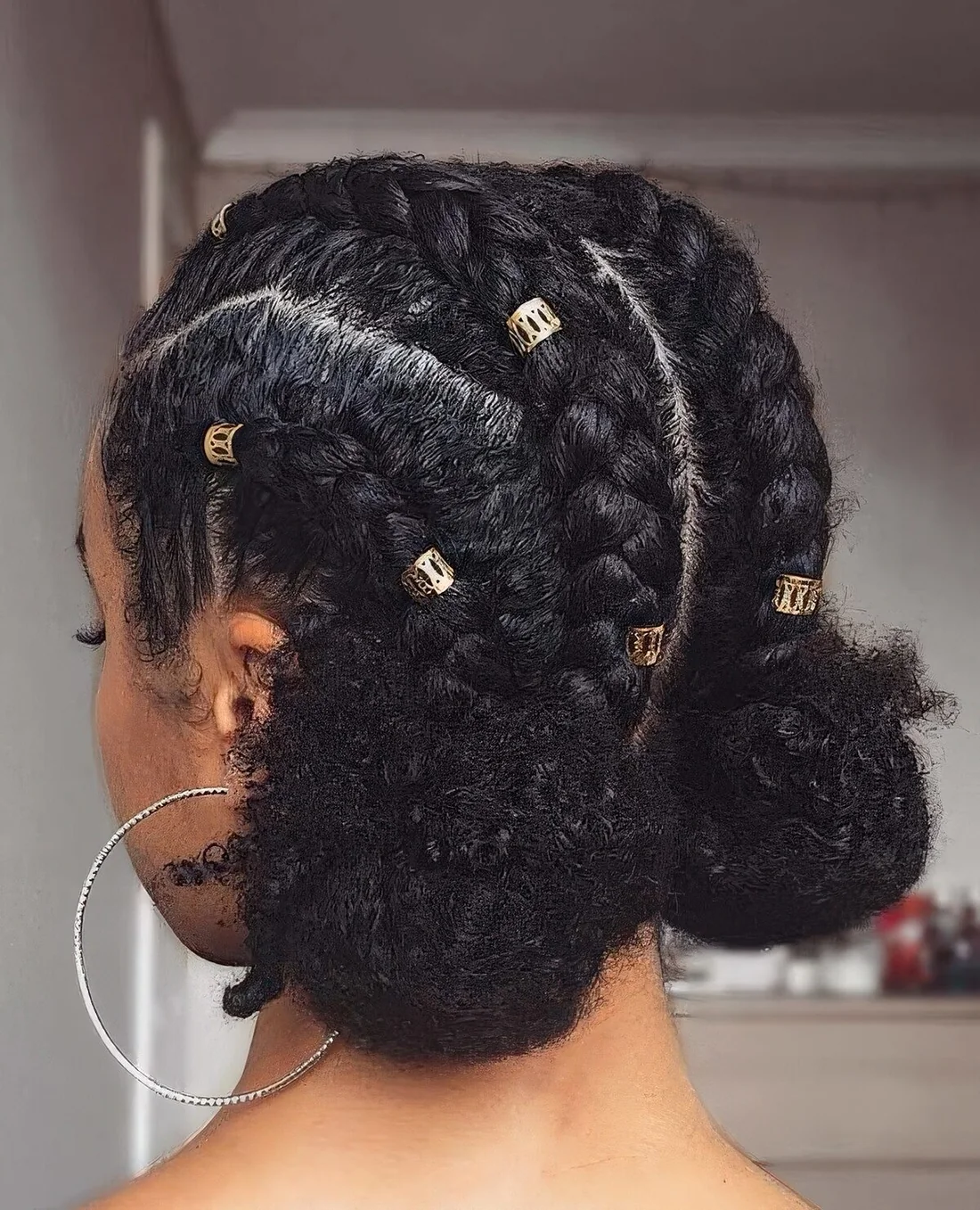 Photo showing cornrows into space buns, with the hairstyle clearly visible.