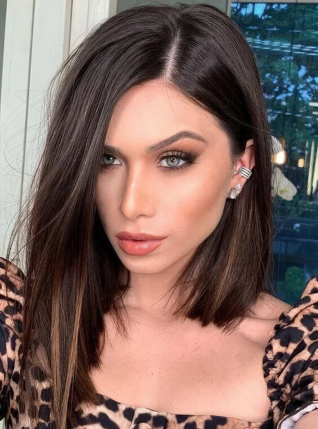 Dark brunette angled long bob with honey lowlights and much volume.