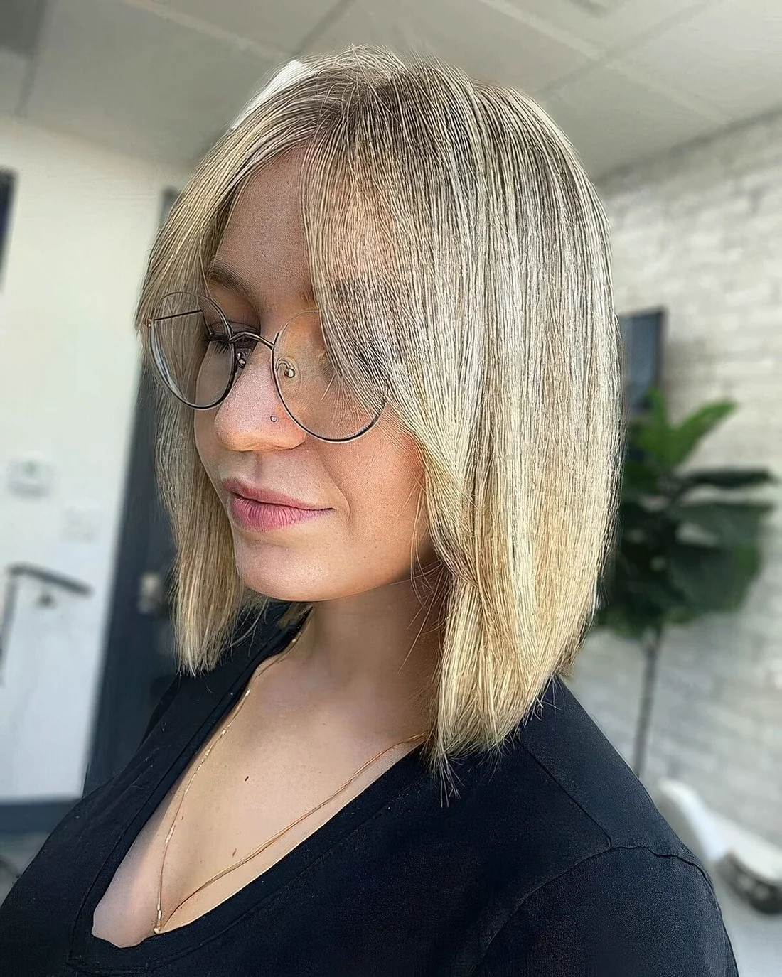 Blonde A line long bob with curtain bangs.