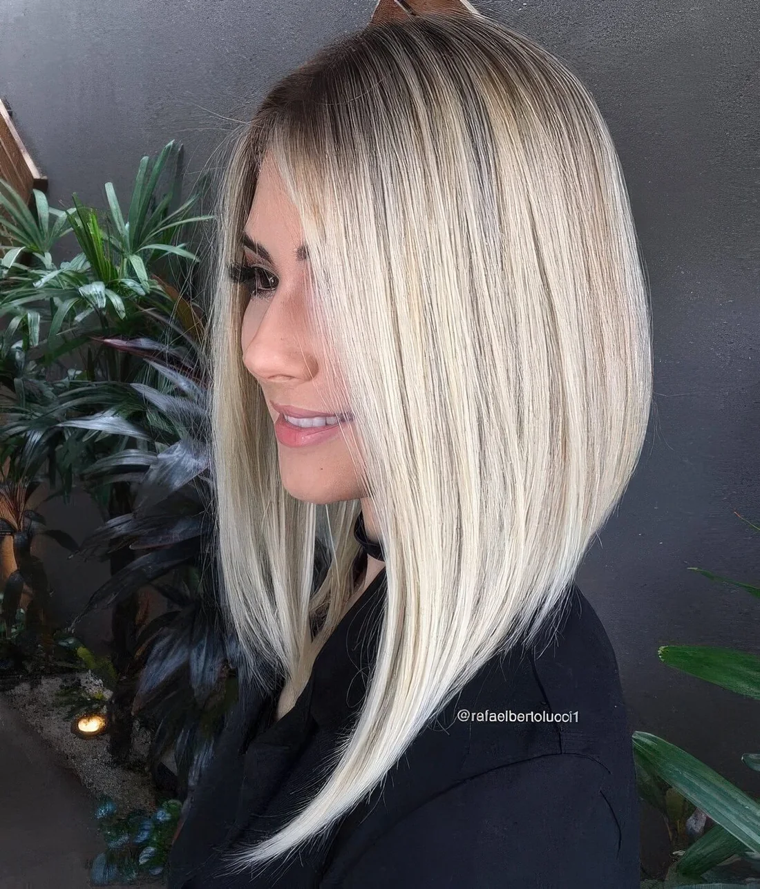 Blonde angled long bob with side part and strict lines.