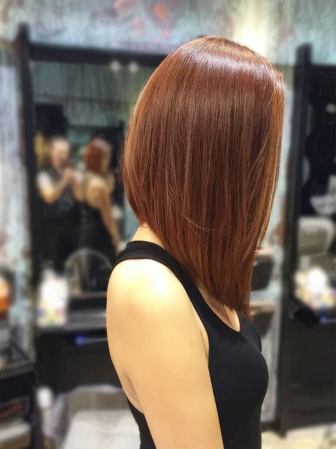 Angled red long bob with a shiny touch.