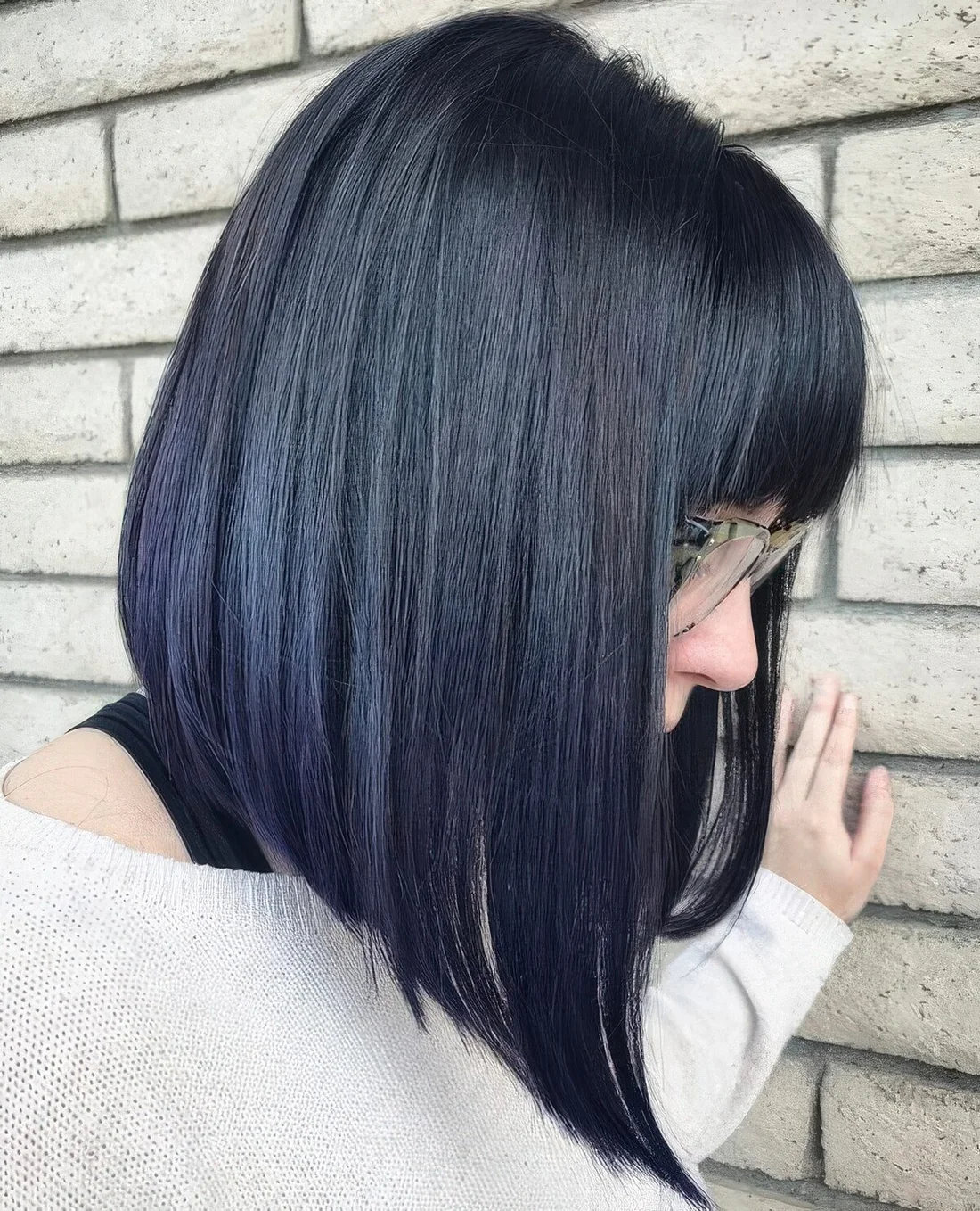 Deep blue angled long bob with a fringe.