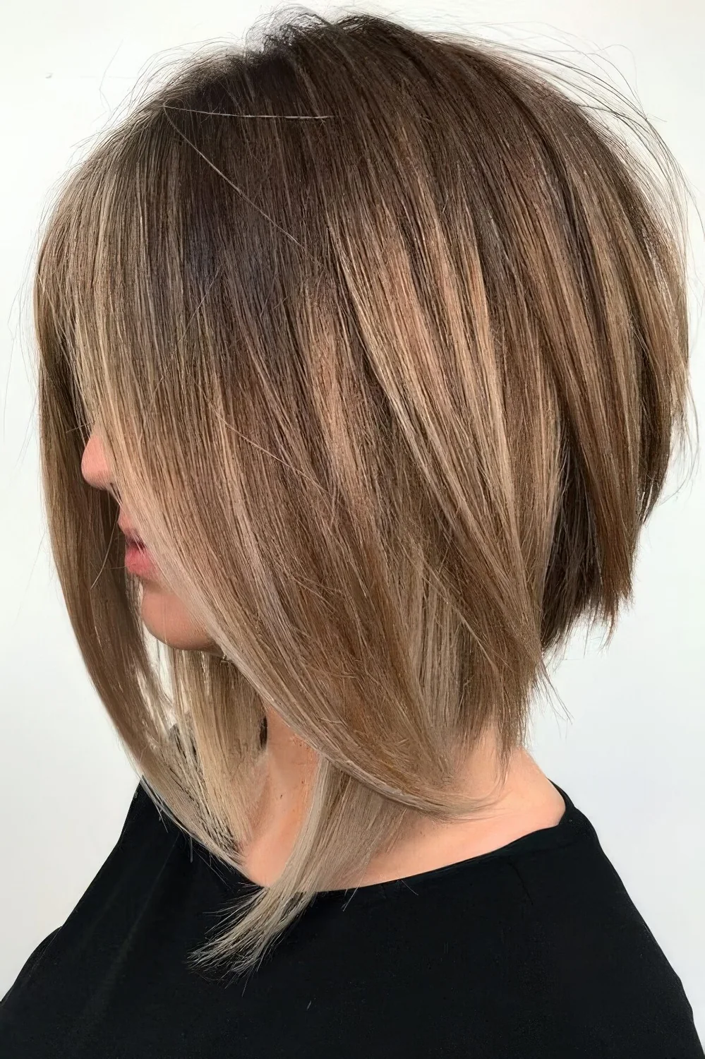 Angled light brunette bob with textures and layered plus some caramel balayage.