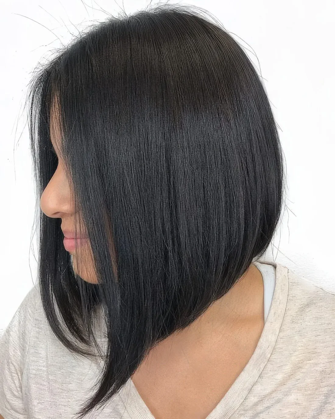 Photo showing sleek black bob with curled ends, with the hairstyle clearly visible.