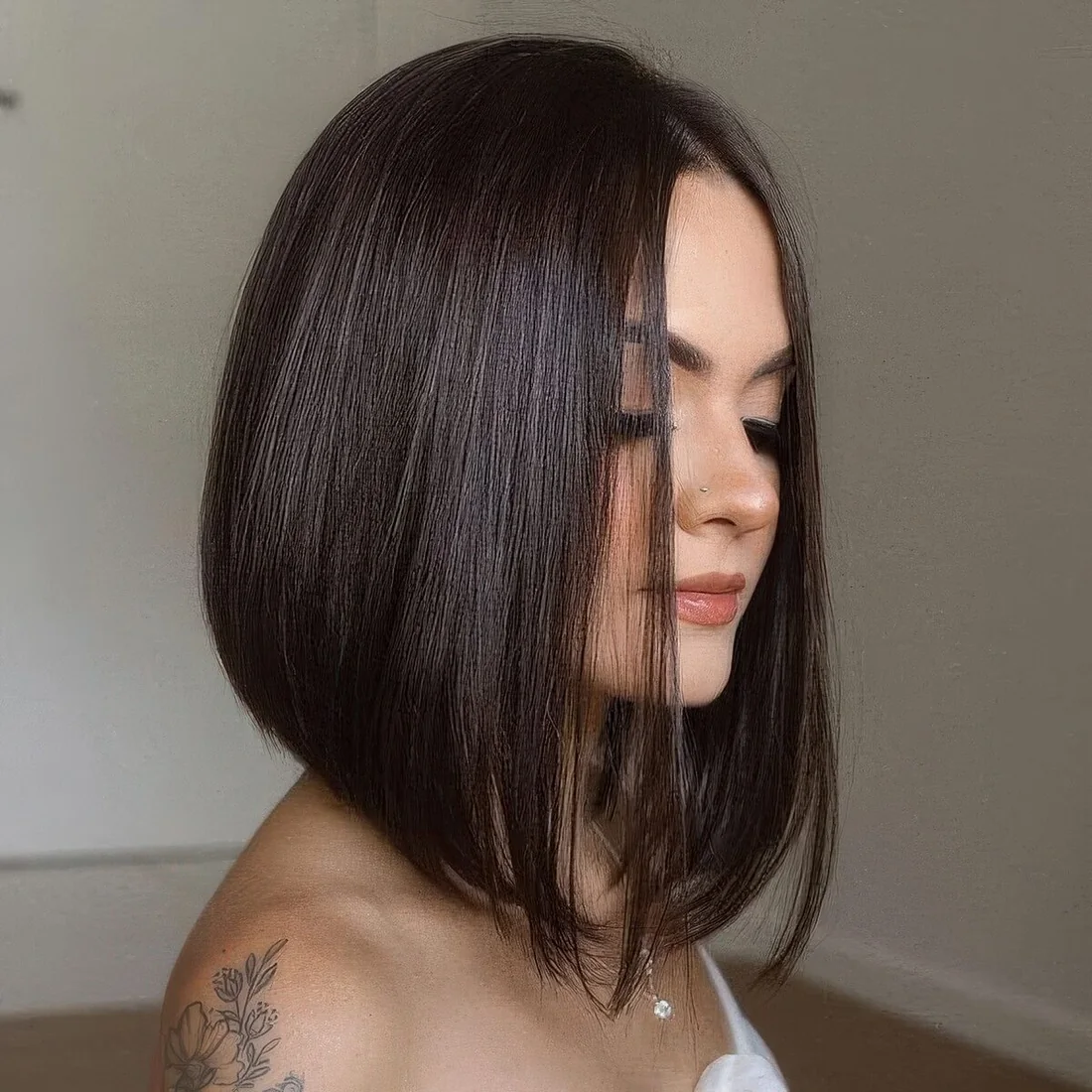 Dark brunette A line bob with curled ends.