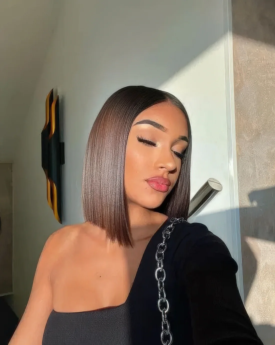 Long chestnut bob with an A line and straight hair.
