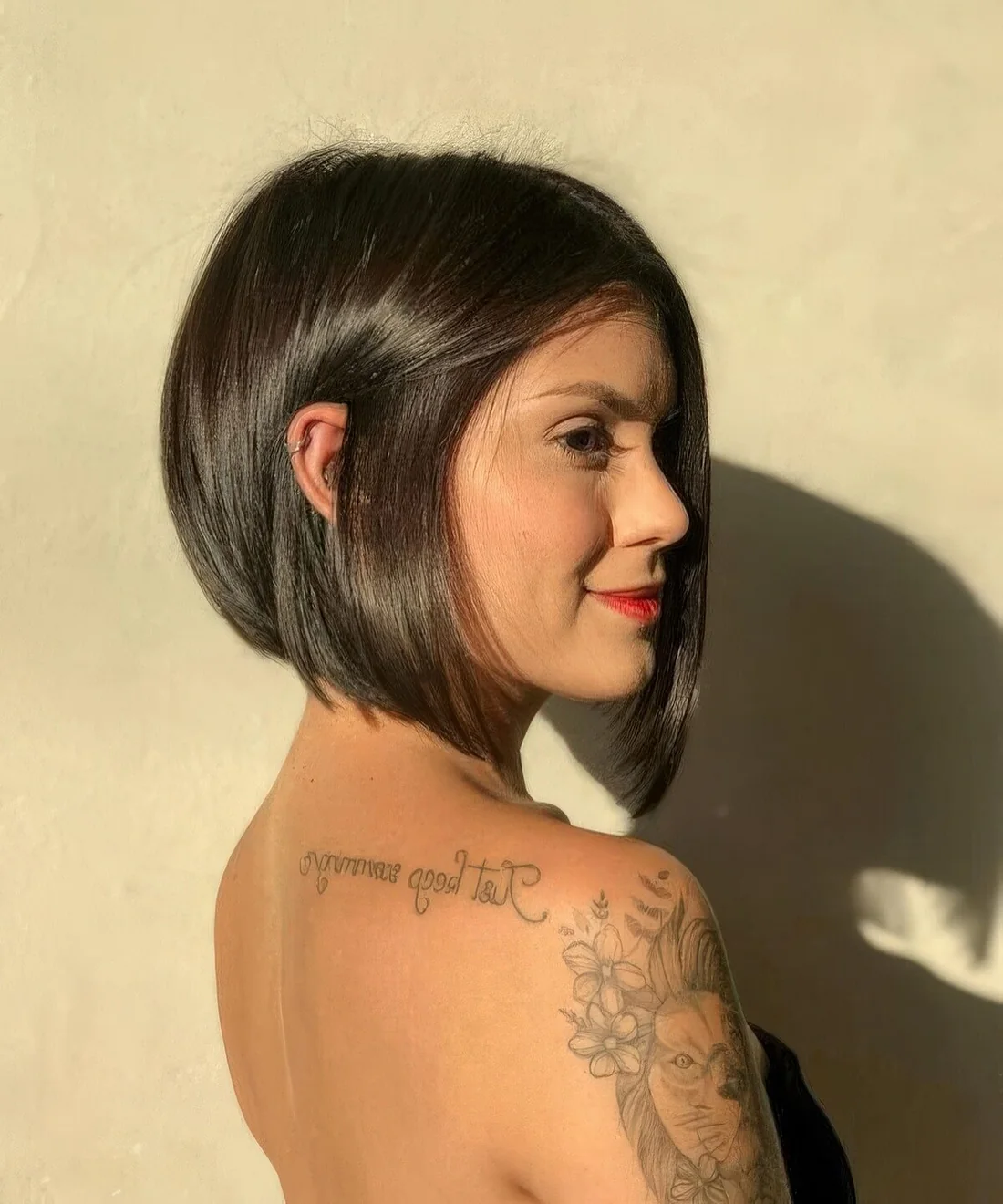 Line black bob with curled ends and a lot of volume.