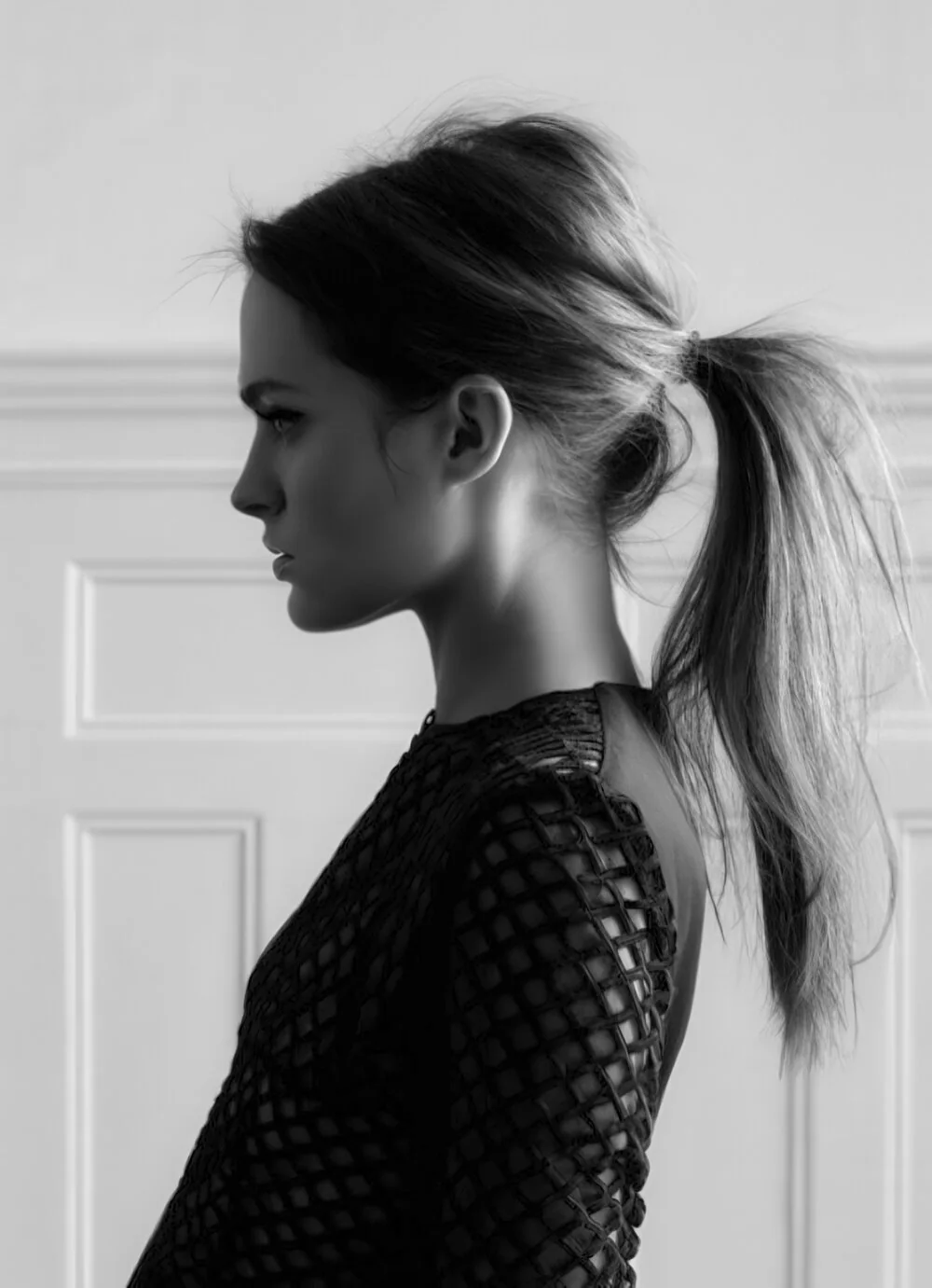 Photo showing tousled brunette high ponytail, with the hairstyle clearly visible.