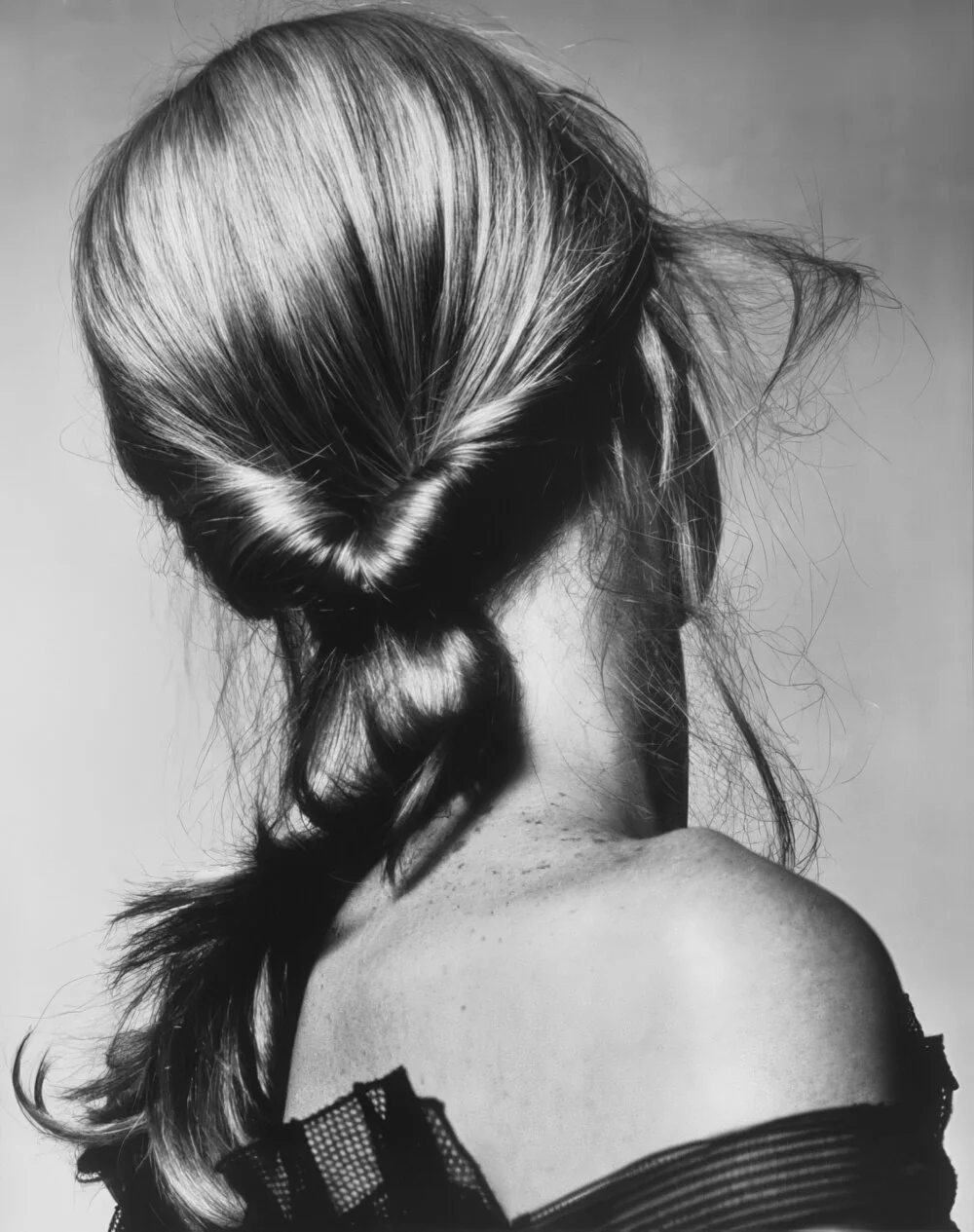 Photo showing low ponytail with a twisted base, with the hairstyle clearly visible.