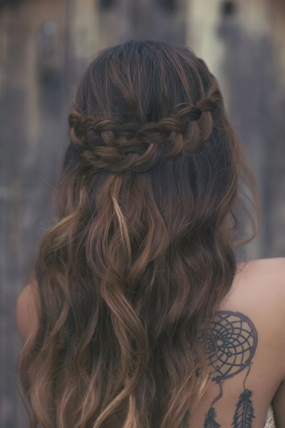 Half-up braided crown with loose waves.