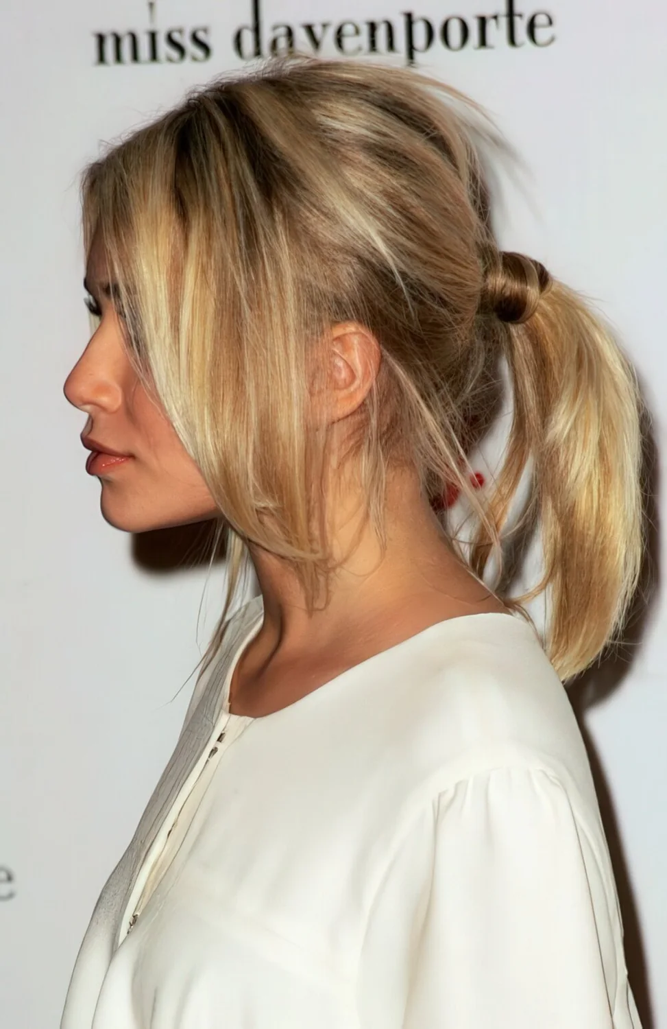 Tousled blonde ponytail with loose front pieces.