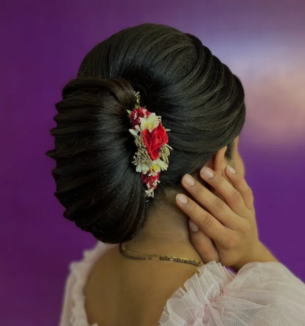 Smooth Tucked Bun With Floral Accent.