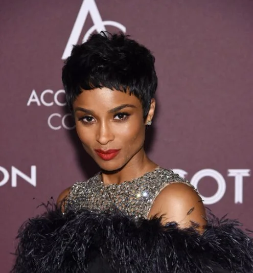 ear straight black pixie with side swept fringe shown as a baby bangs idea
