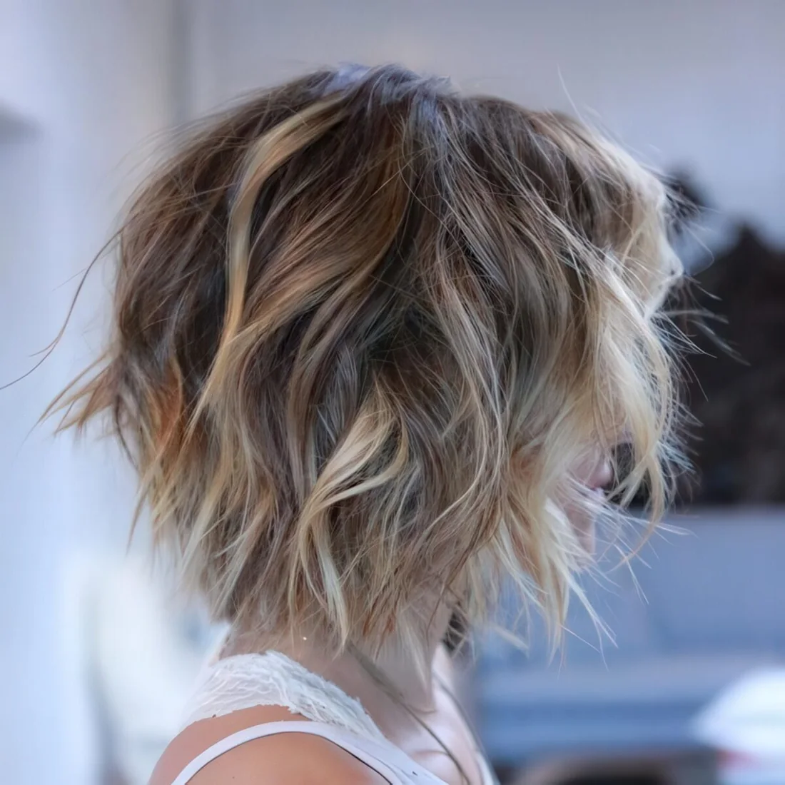 Short bob with shaggy layers done in blonde.