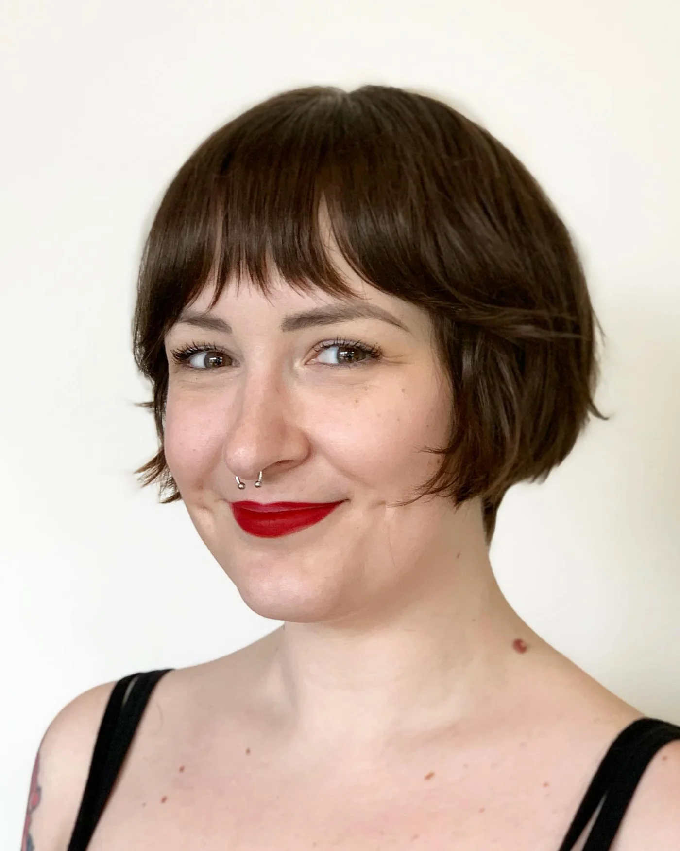 chin straight brunette bob with blunt fringe shown as a bangs for round face idea
