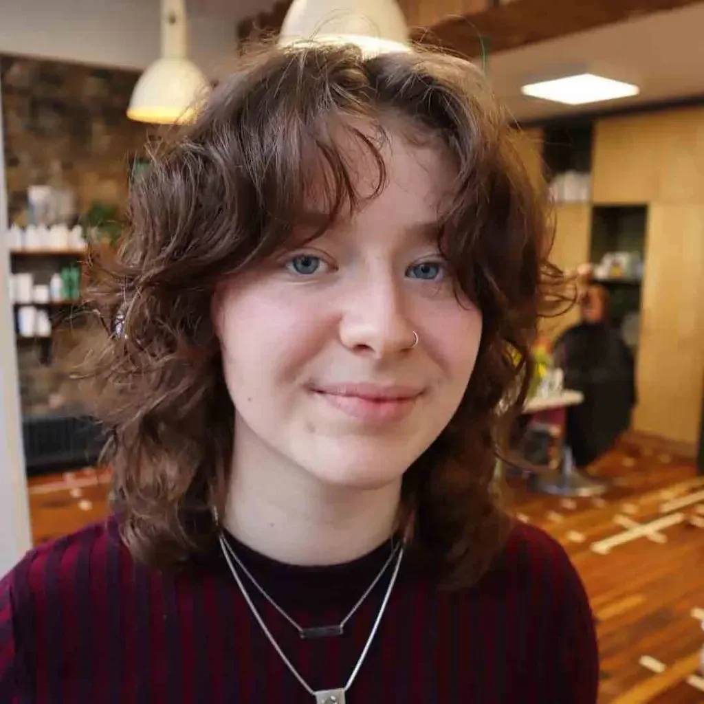 short curly brunette shag with curly fringe fringe shown as a bangs for round face idea