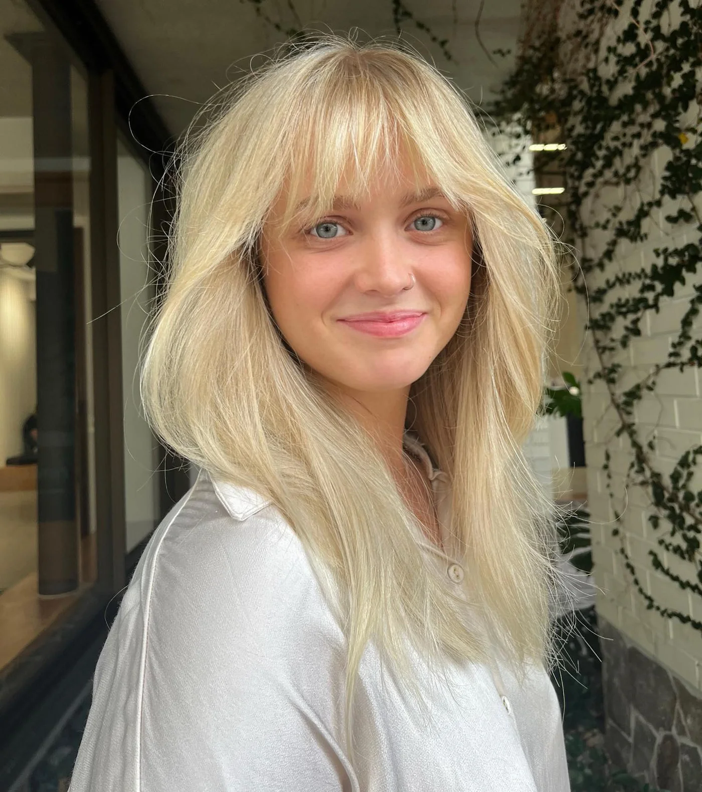 shoulder wavy honey shag with curtain fringe shown as a bangs for round face idea, featuring center part