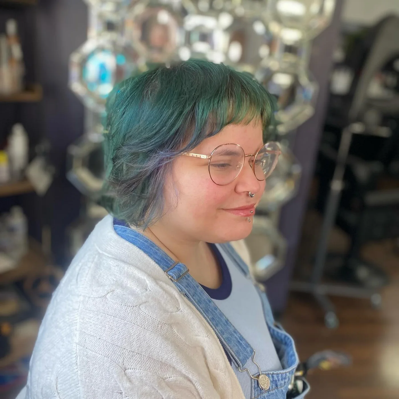 neck wavy teal shag with wispy fringe shown as a bangs for round face idea