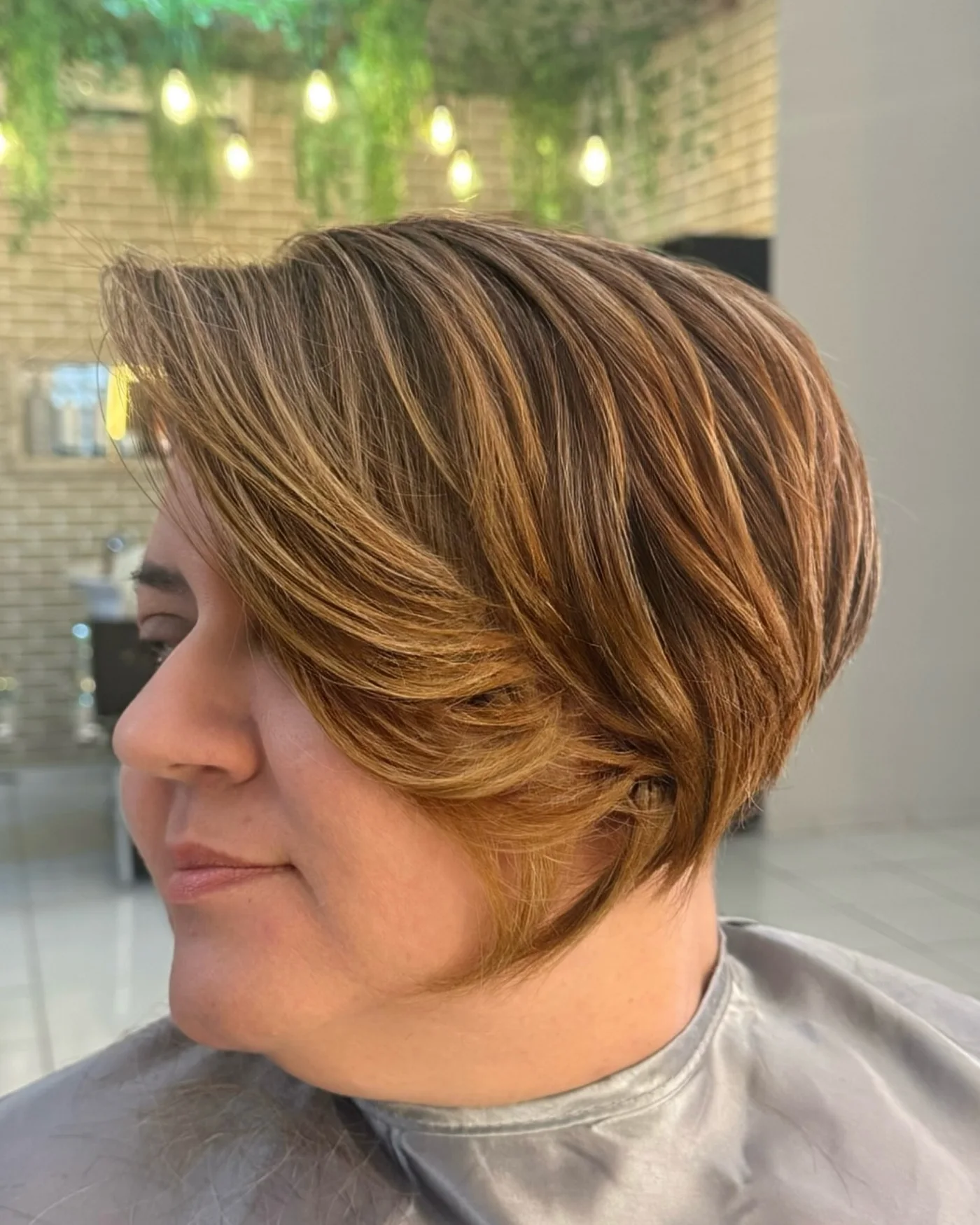 ear straight caramel pixie with side swept fringe shown as a bangs for round face idea