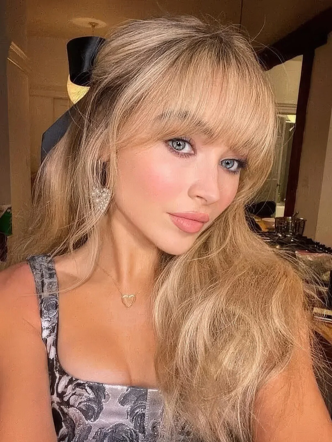 Naturally blonde shade on long hair and Bardot wispy bangs.