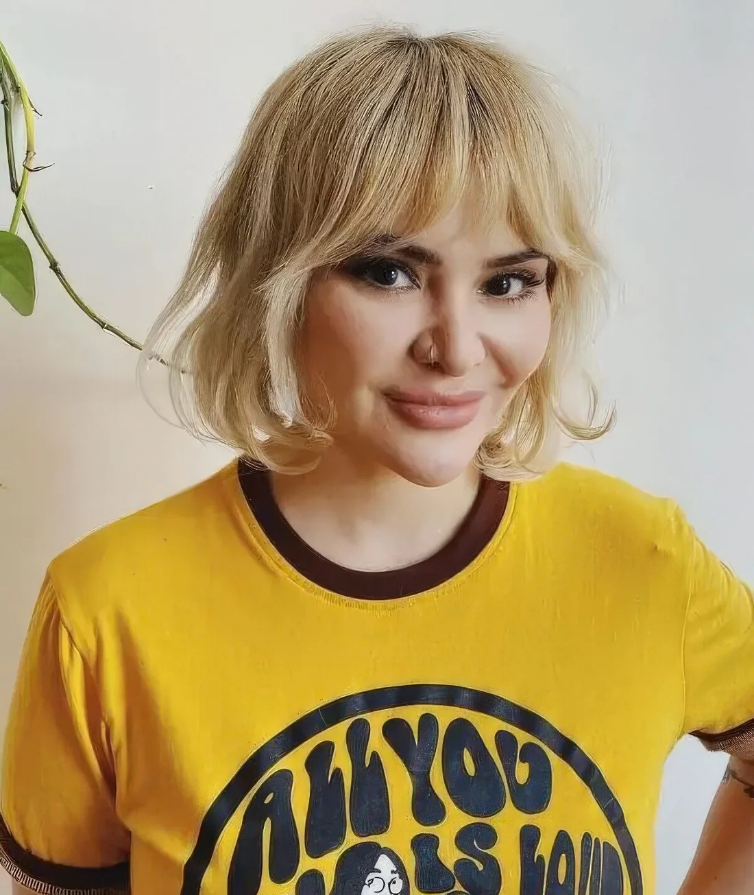Chin-length blonde layered bob with Bardot fringe plus some curls for a catchy and whimsy look.